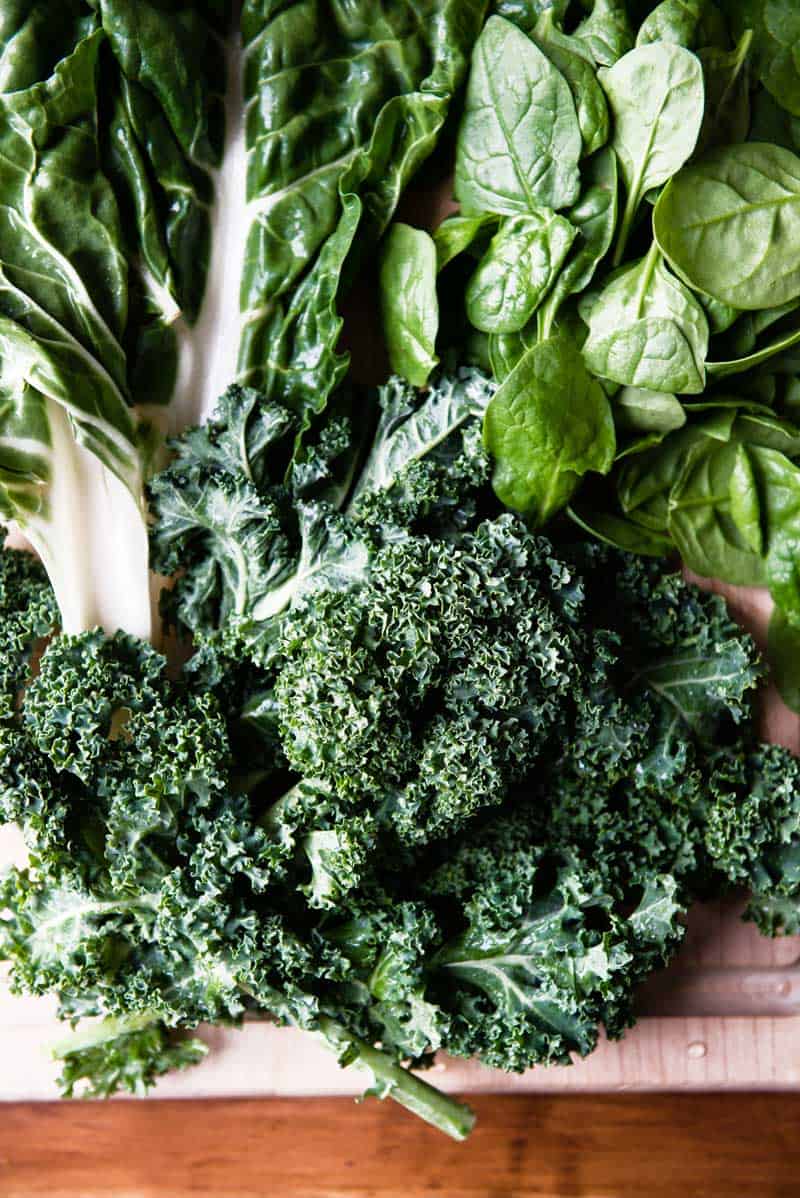 just washed dark leafy greens on a cutting board