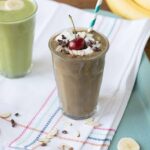 Nutritious banana split green smoothie with coconut whipped cream