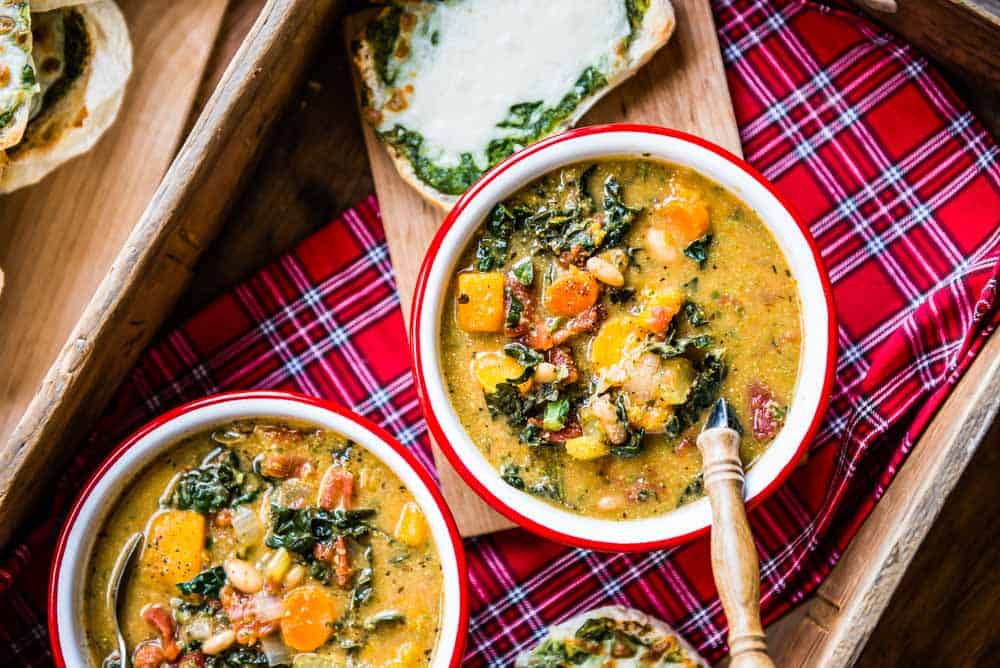 two bowls of vegan minestrone soup, ready to eat. 