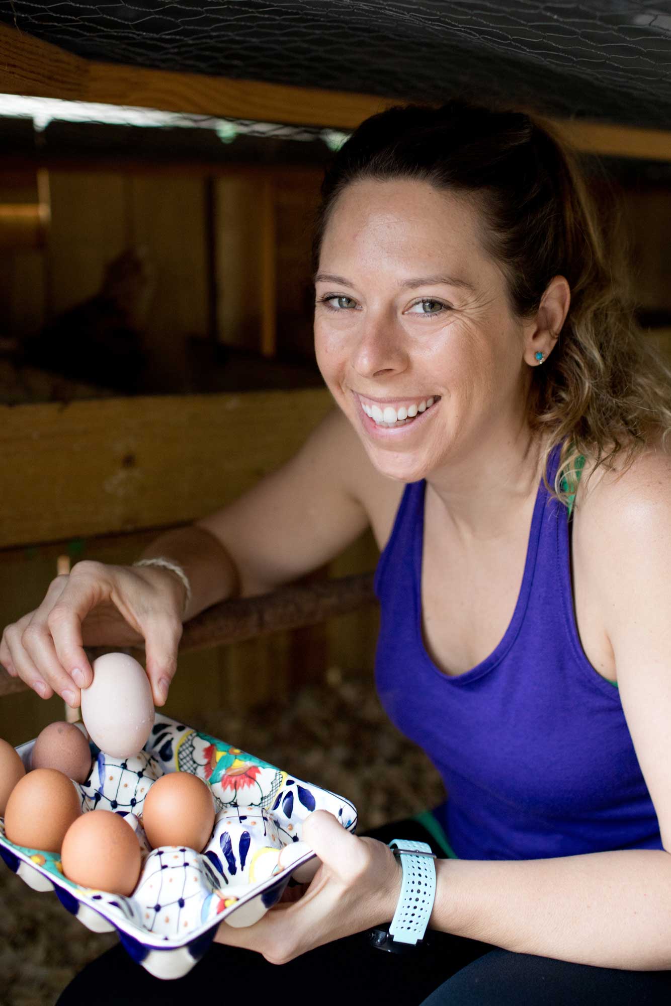 Jen Hansard collecting eggs from backyard coop