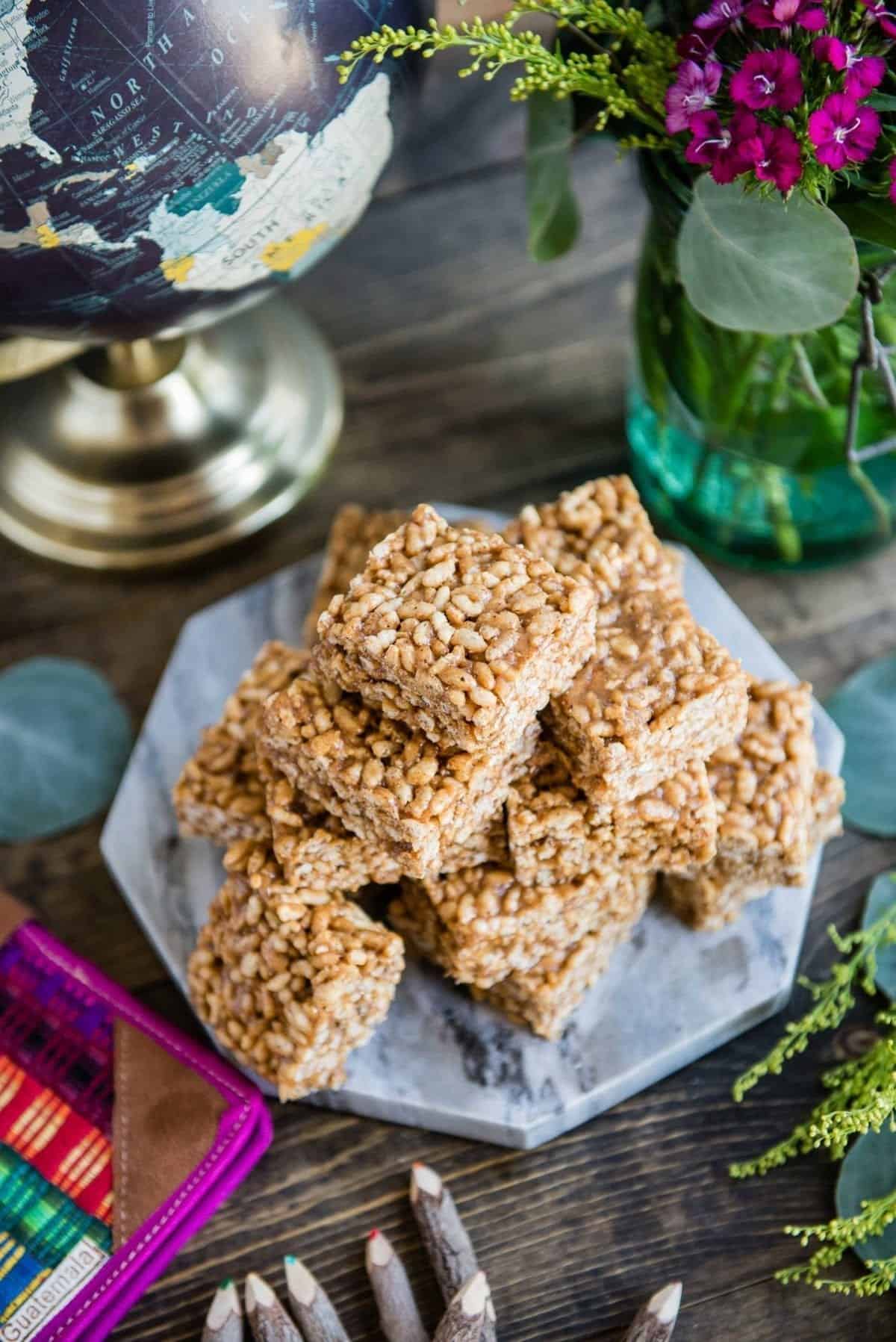 freshly made rice crispy treat recipe prepared for kids on a wood table