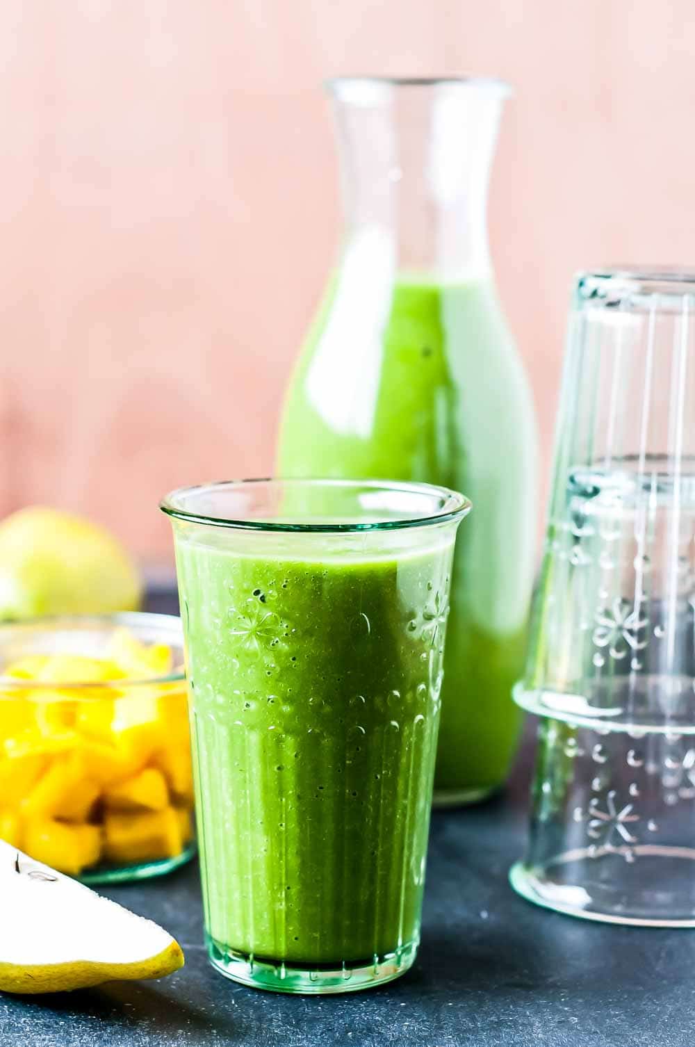bright green smoothie in a decorative glass.