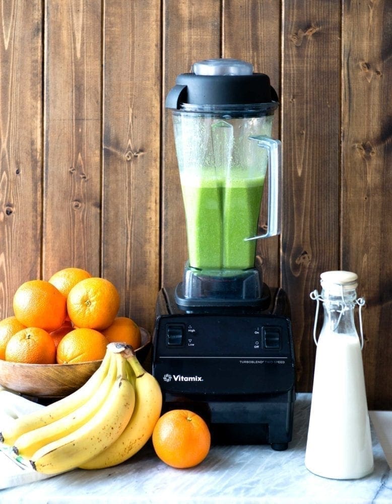 Vitamix blender mixing an orange julius smoothie