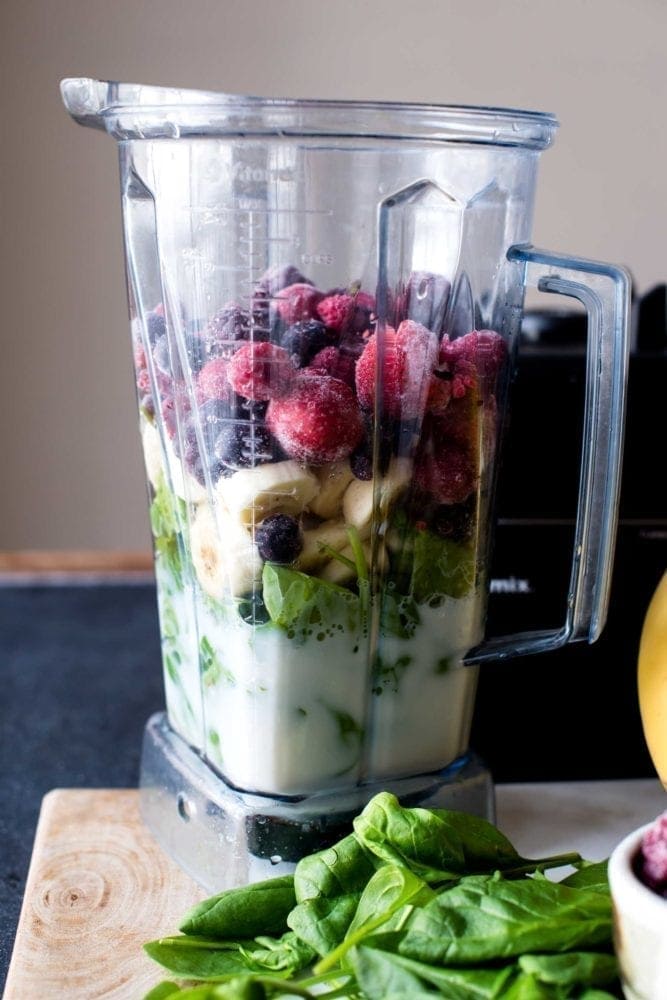 Blending ingredients for berry smoothie