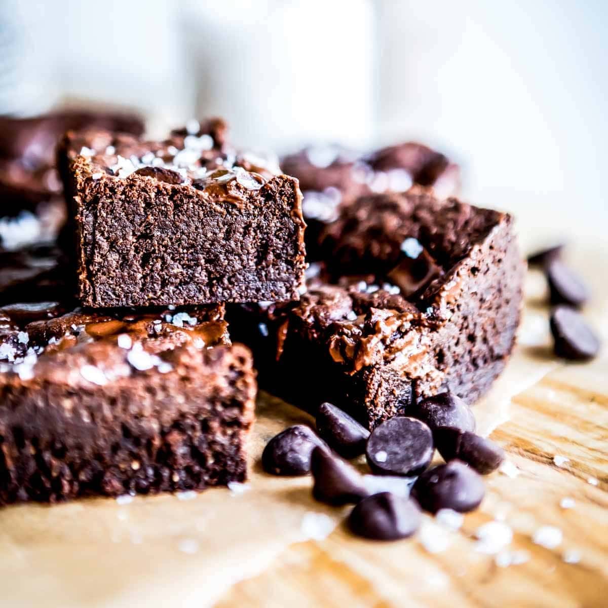 three rich fudgy brownies surrounded by chocolate chips.