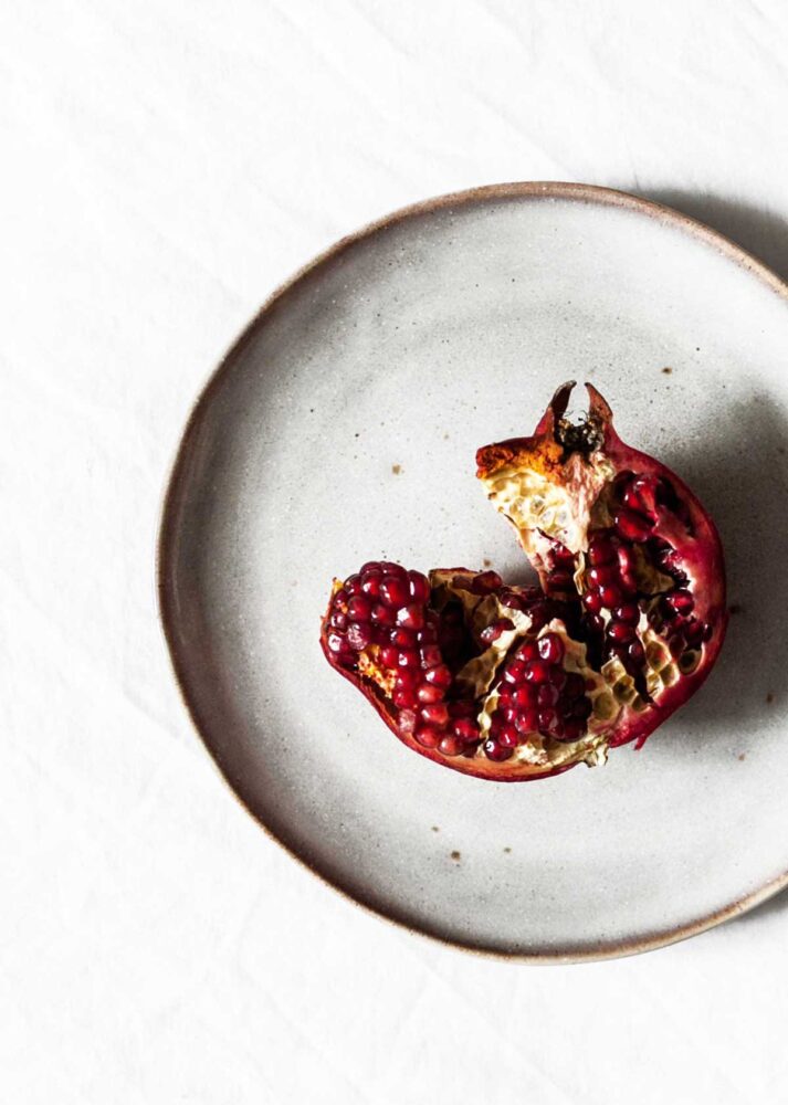 plate with fresh pomegranate seeds on it