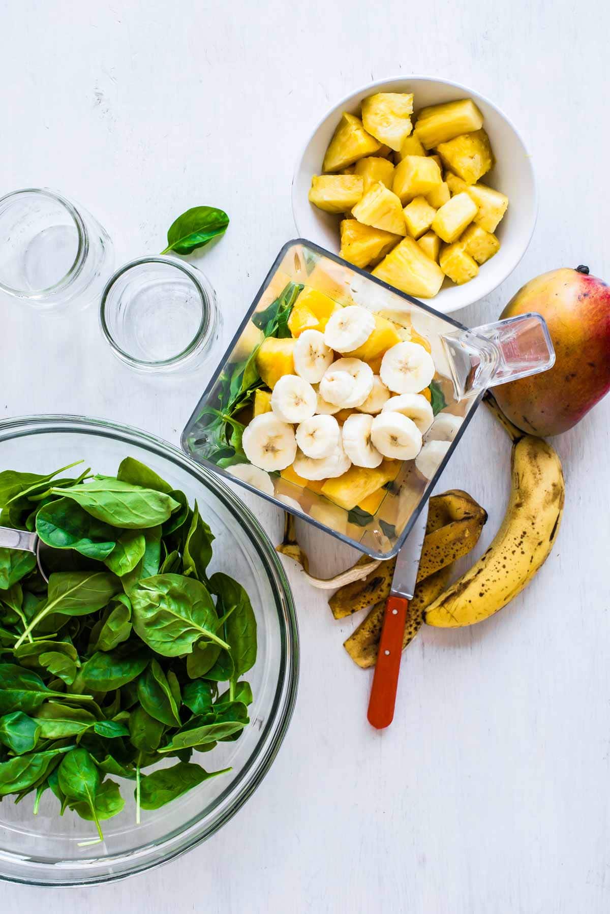 Freshly cut bananas and pineapple to make a green smoothie recipe.