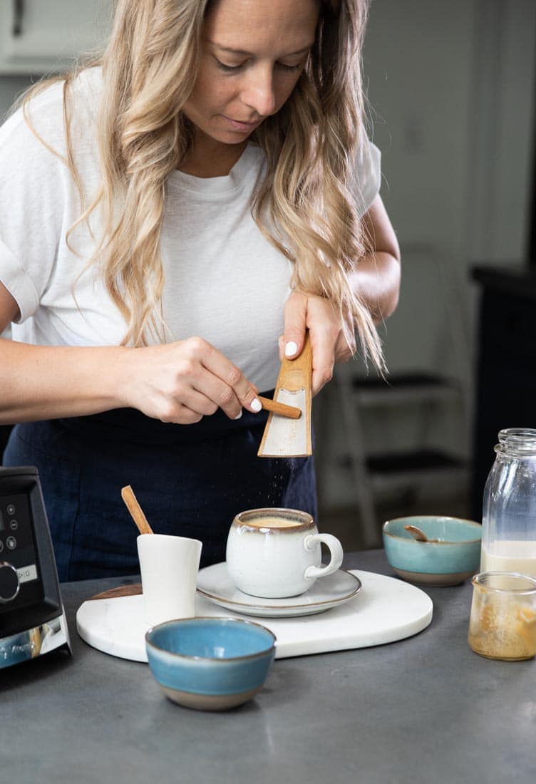 Jen Hansard grinding cinnamon stick into freshly ground powder for latte.