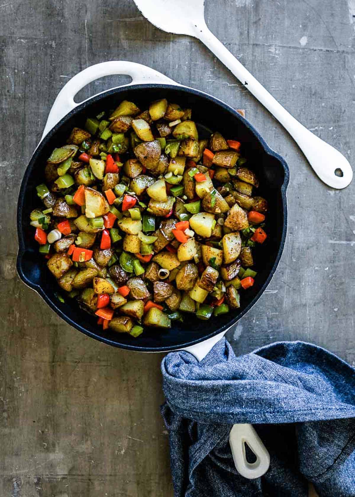 Breakfast bowl ingredients in a skillet.