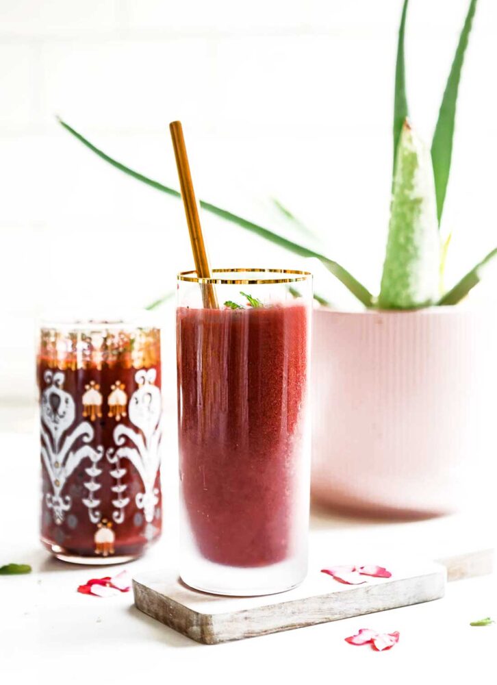 Cherry beet smoothie with metal straw