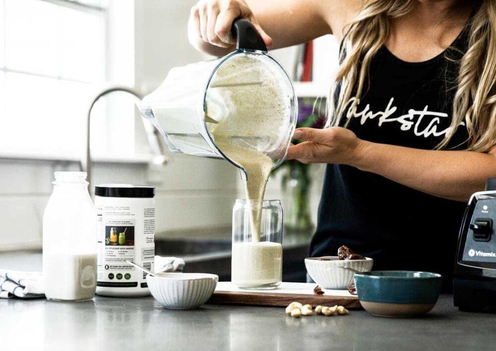 Pouring Vanilla Protein Shake into a jar