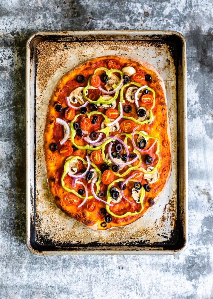 Vegan Pizza Recipe on a baking tray with veggies