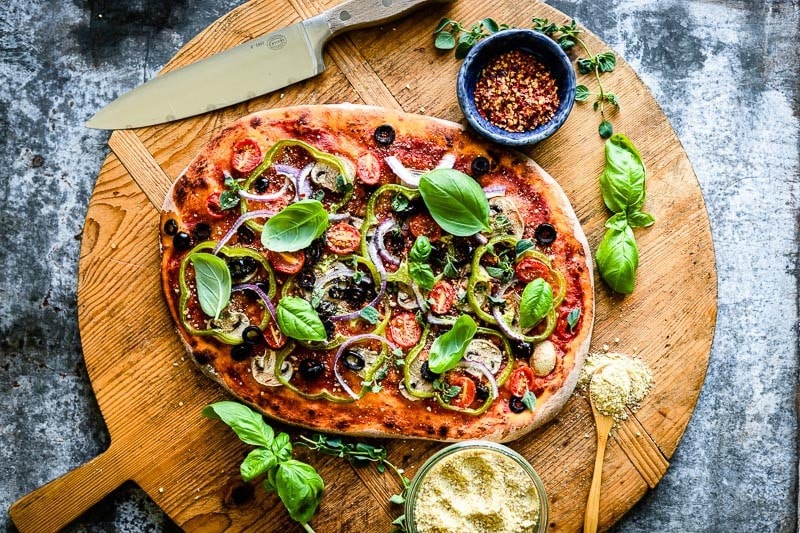 fresh basil on a vegetable pizza