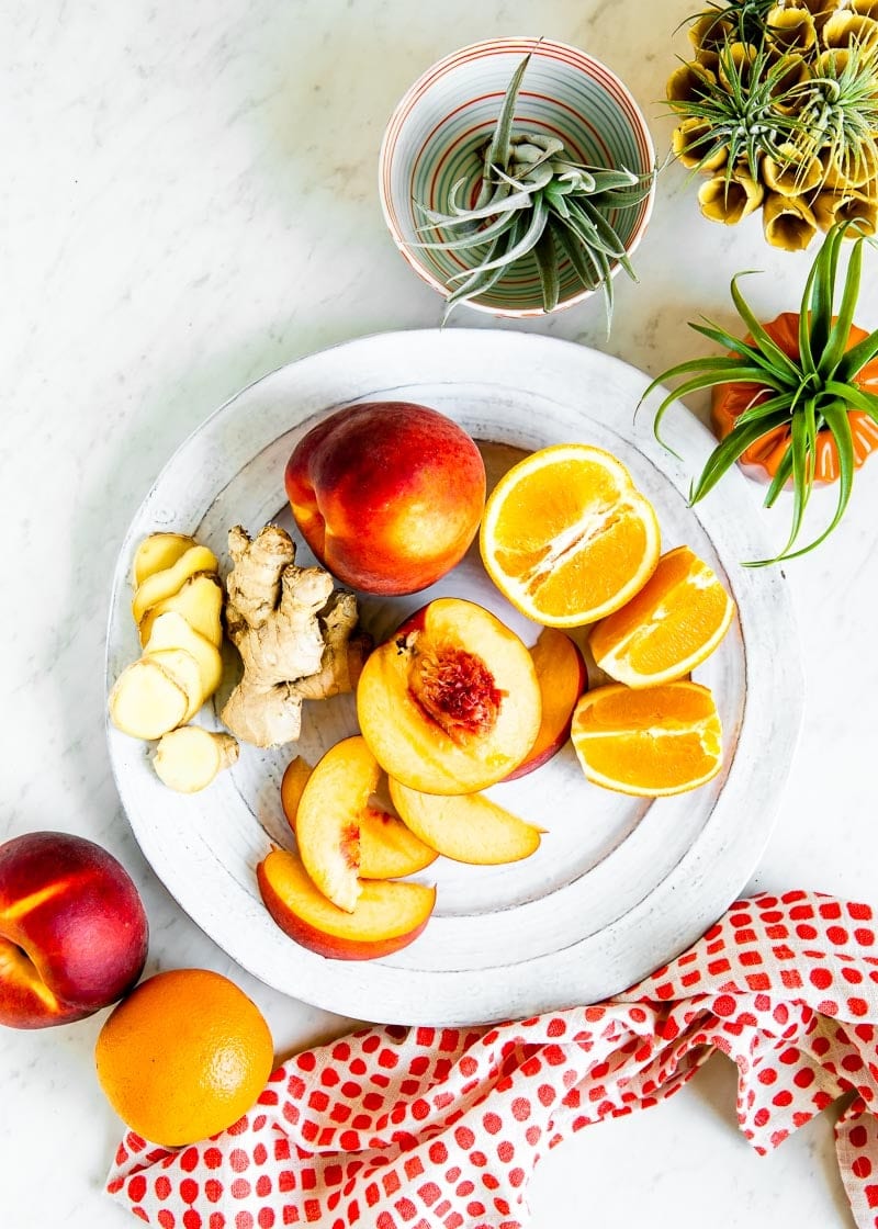 Ingredients to make a peach smoothie include ginger, orange, peaches and water.  |  Simple Green Smoothies