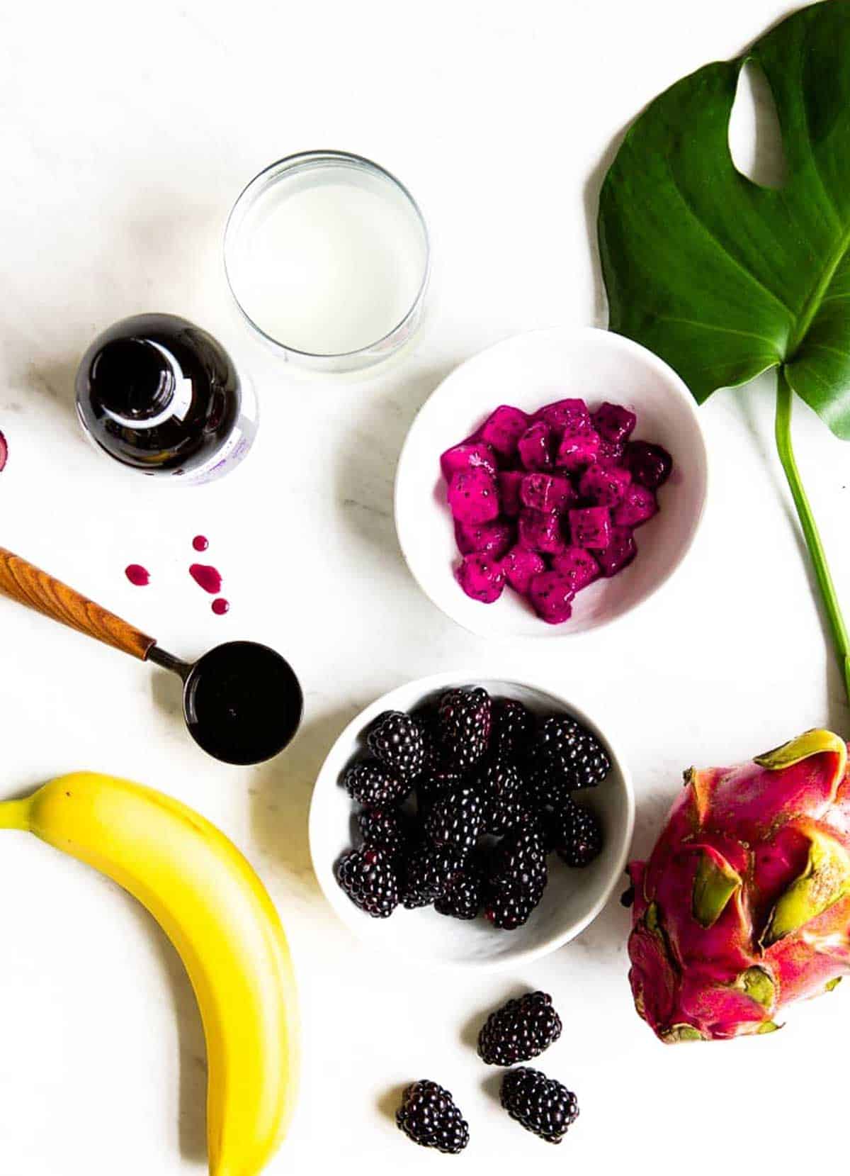 Ingredients in an elderberry smoothie including dragon fruit cubes, elderberry syrup, blackberries and banana.