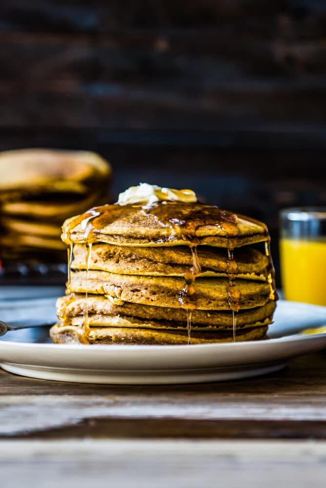 an up close shot of beautifully stacked pumpkin pancakes