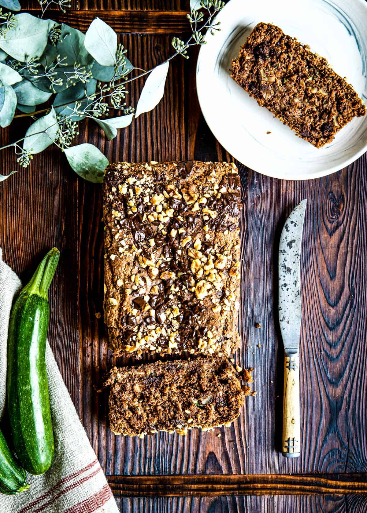 slices of zucchini bread next to a loaf.