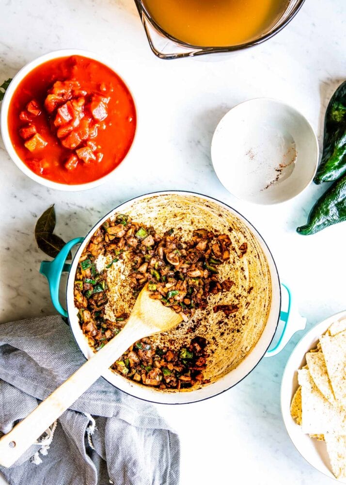 sáuting the veggies before blending them in this vegetarian tortilla soup helps maximize the flavor