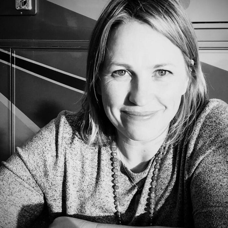 Black and white photo of a smiling woman.
