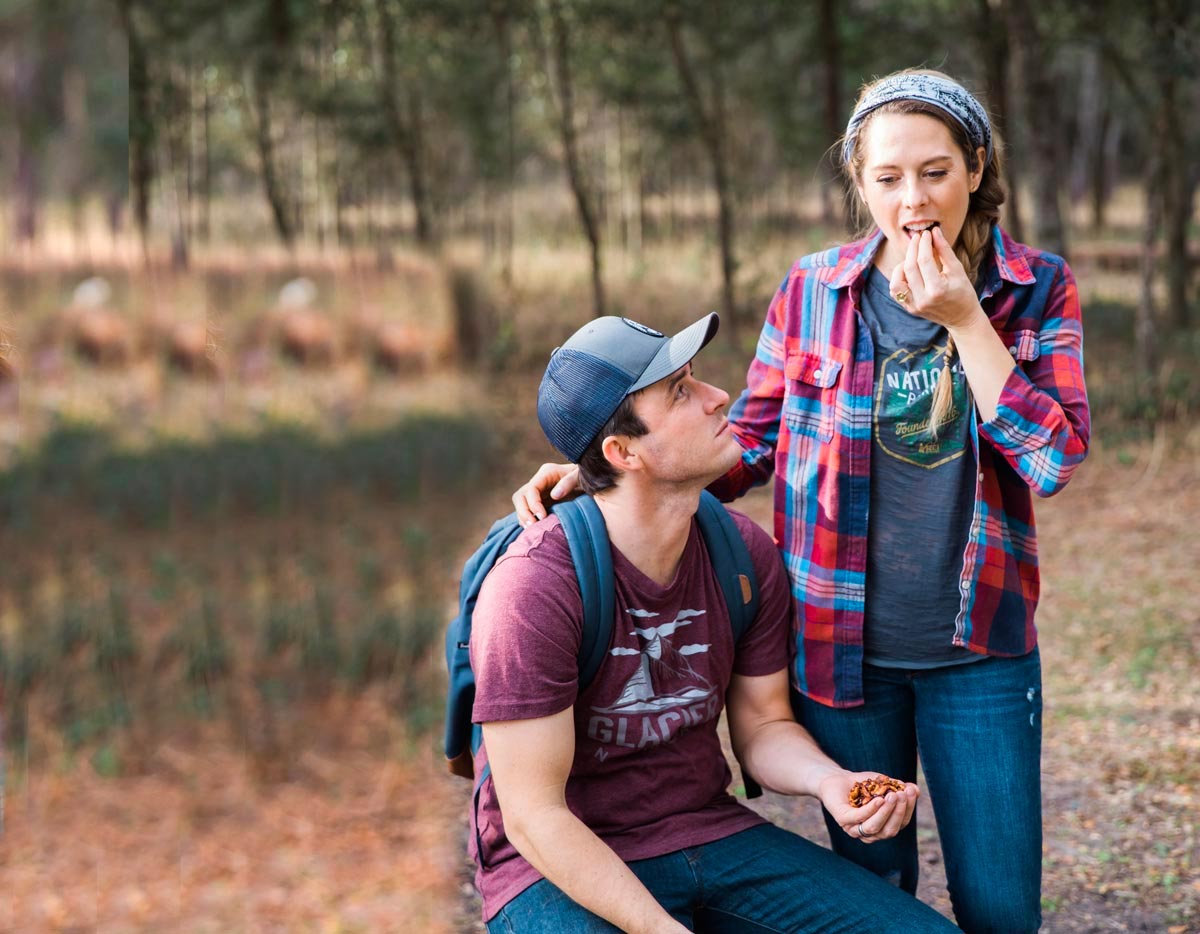 woman eating Plant-Based Cleanse recipe in a park with a man.