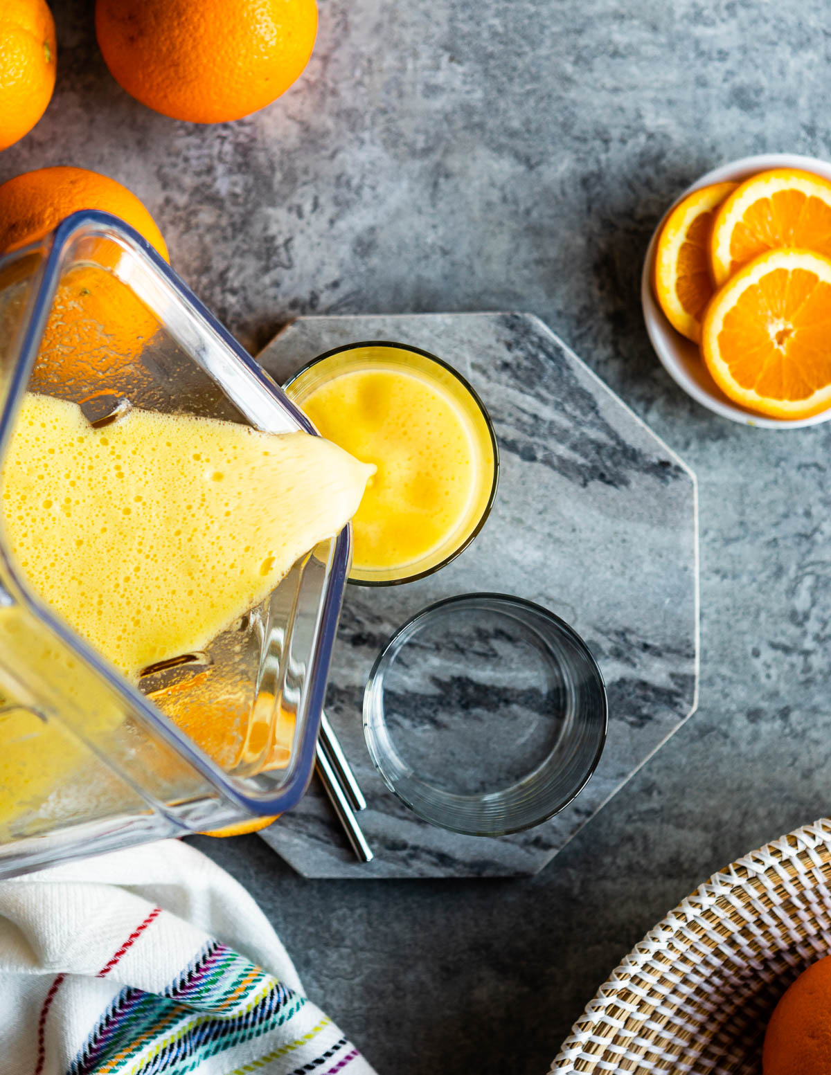 Citrusy adrenal cocktails being poured in glasses to serve. 