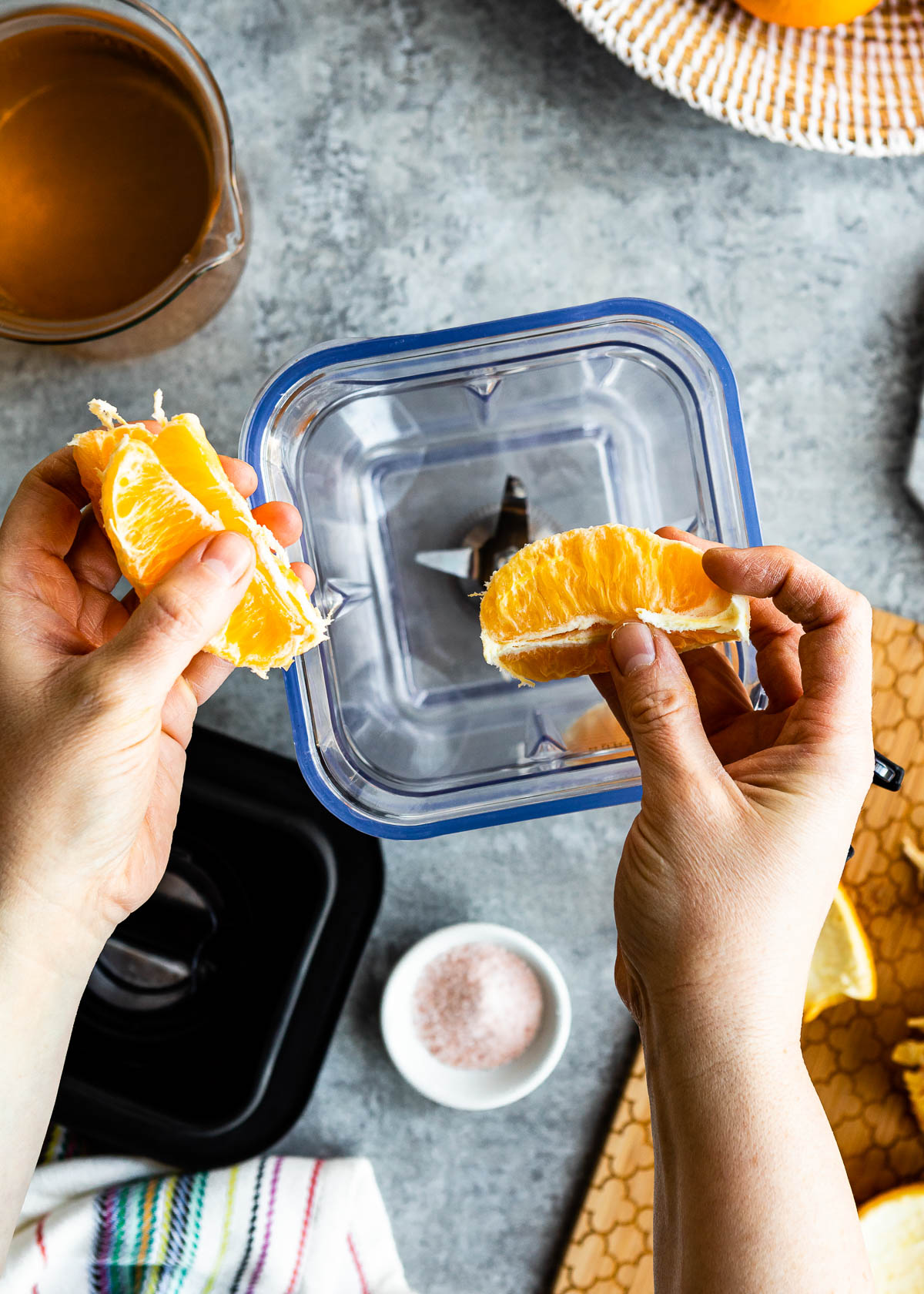 Adding orange slices in a blender