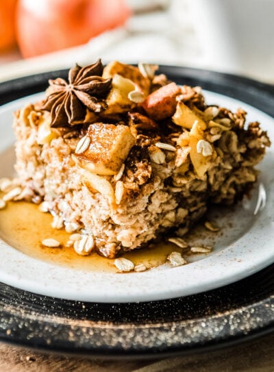 Delicious cinnamon apple baked oatmeal with toppings on a plate.