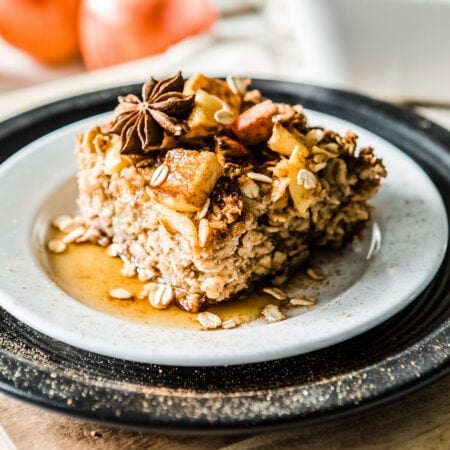Delicious cinnamon apple baked oatmeal with toppings on a plate.