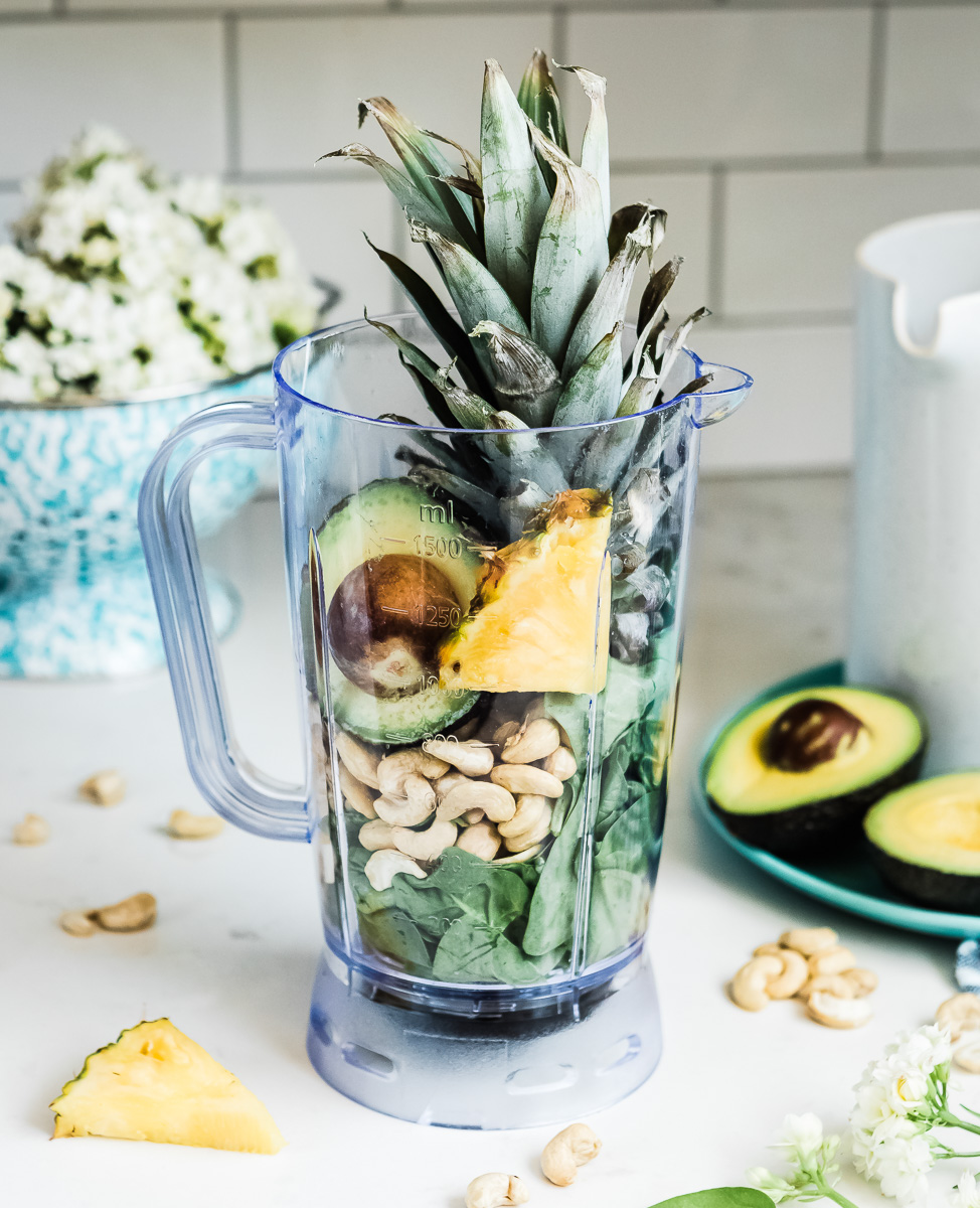 Whole food ingredients for a creamy green avocado smoothie.