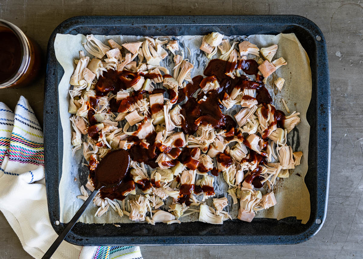 Lined tray of jackfruit with barbeque sauce.