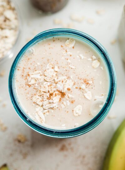 Creamy banana oatmeal smoothie served in a glass.