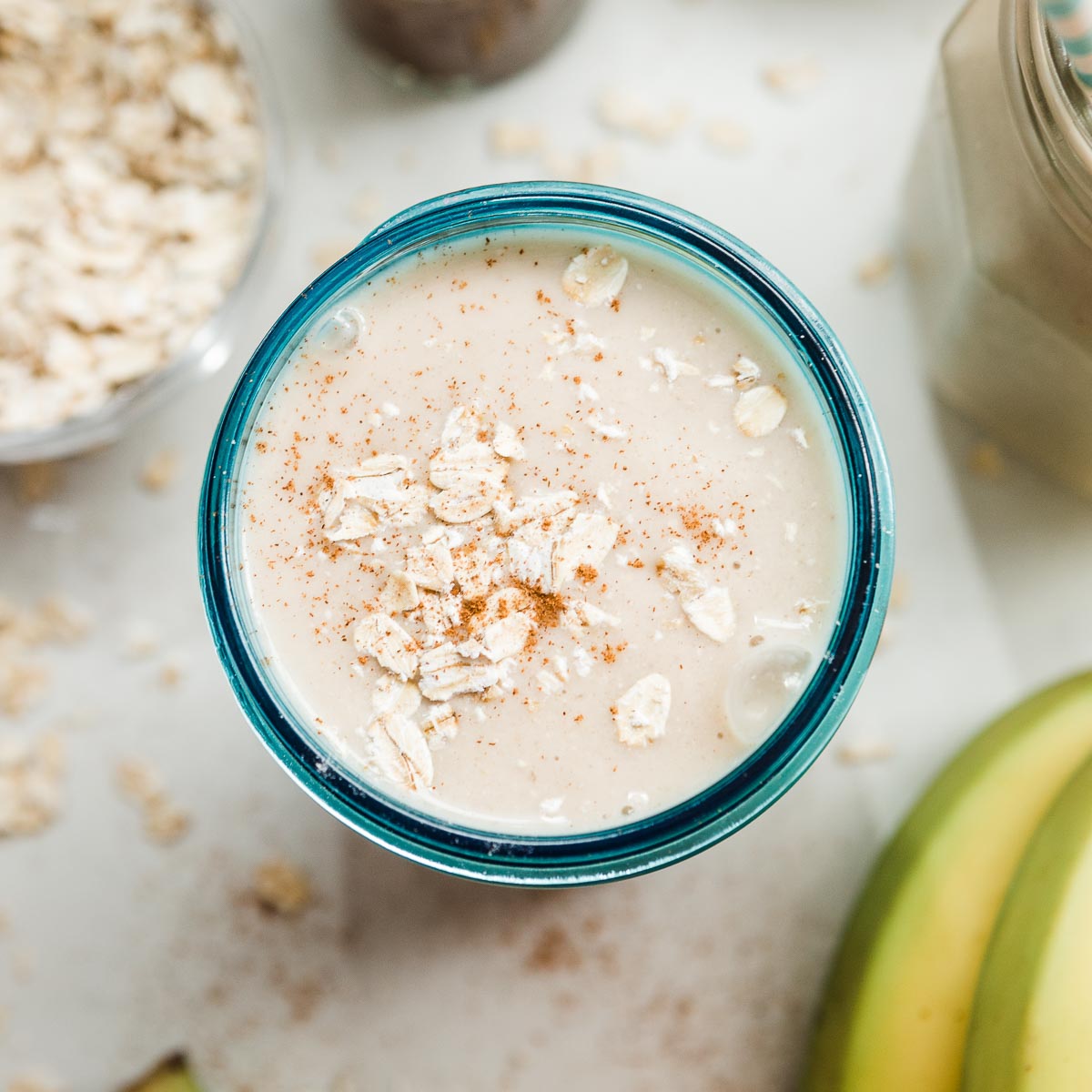 Creamy banana oatmeal smoothie served in a glass.