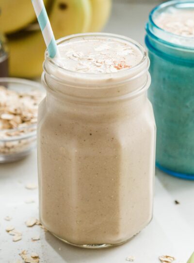 Two jars with banana oatmeal smoothie.