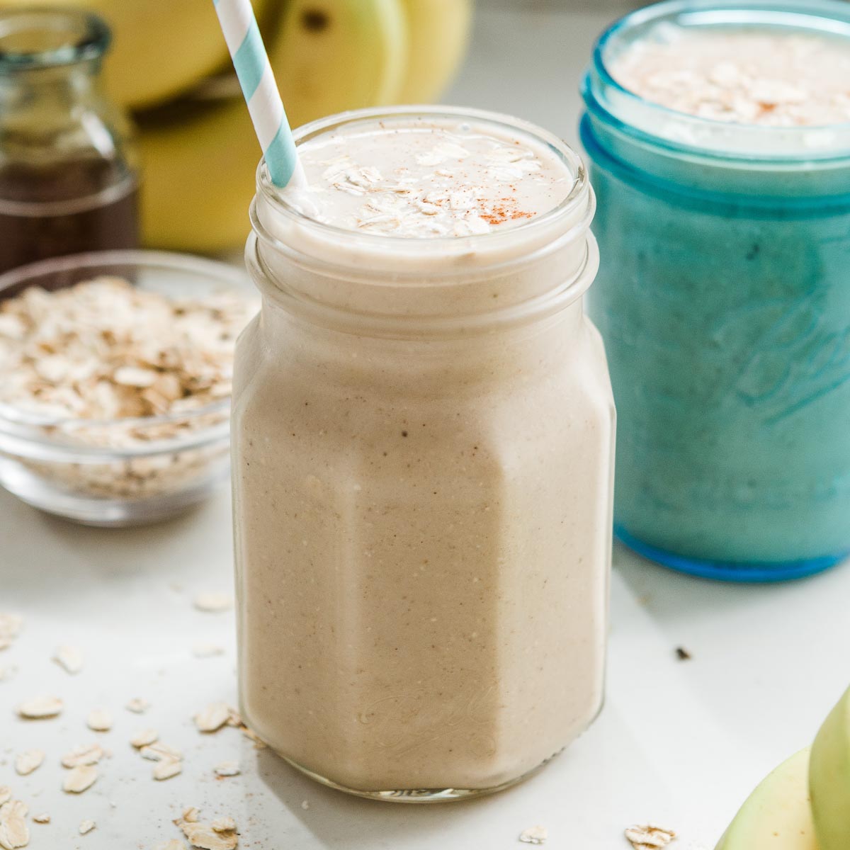 Two jars with banana oatmeal smoothie.