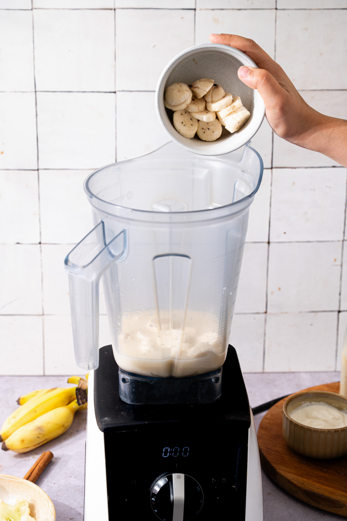 Adding banana slices in a blender