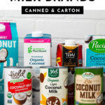 7 coconut milk brands grouped on a countertop with a white brick background.