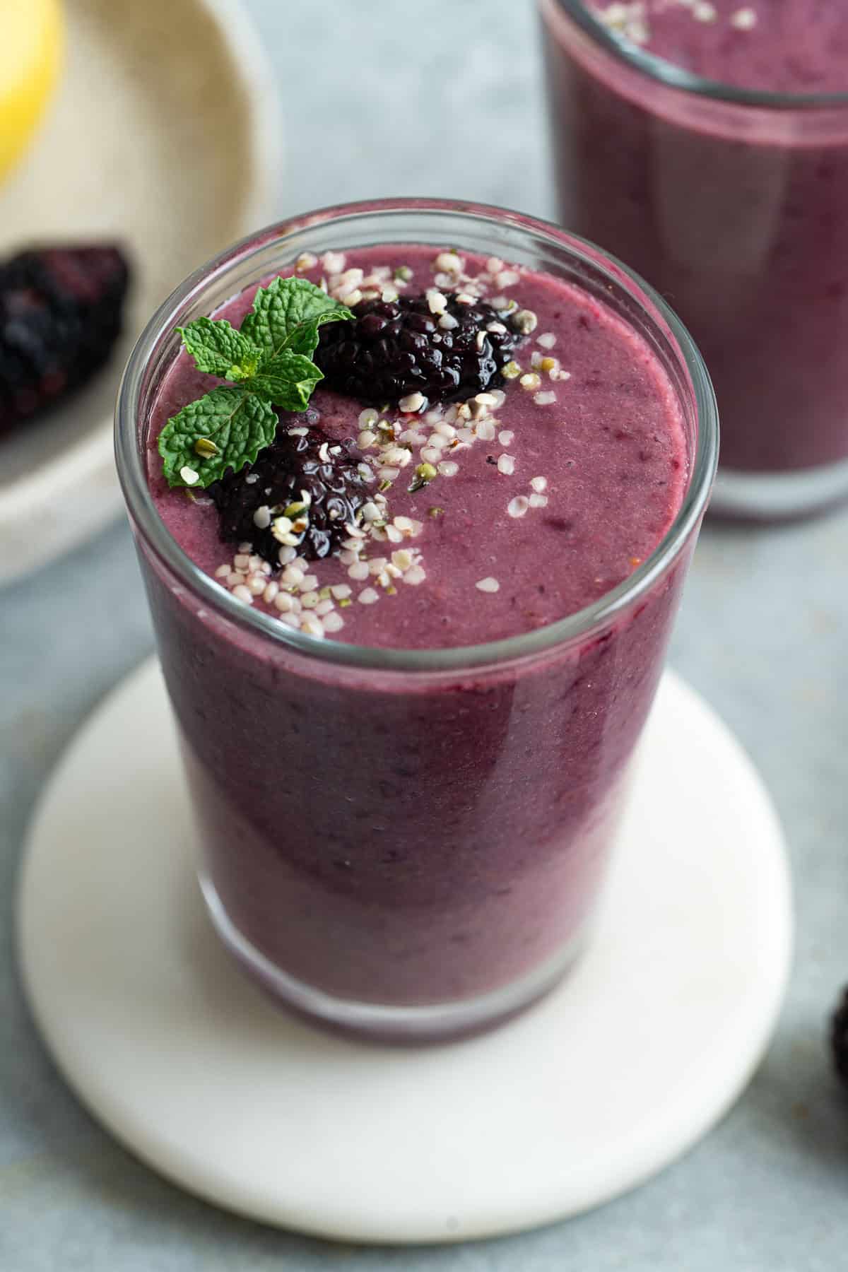 Blackberry smoothie garnished with fresh blackberries, hemp hearts, and mint
