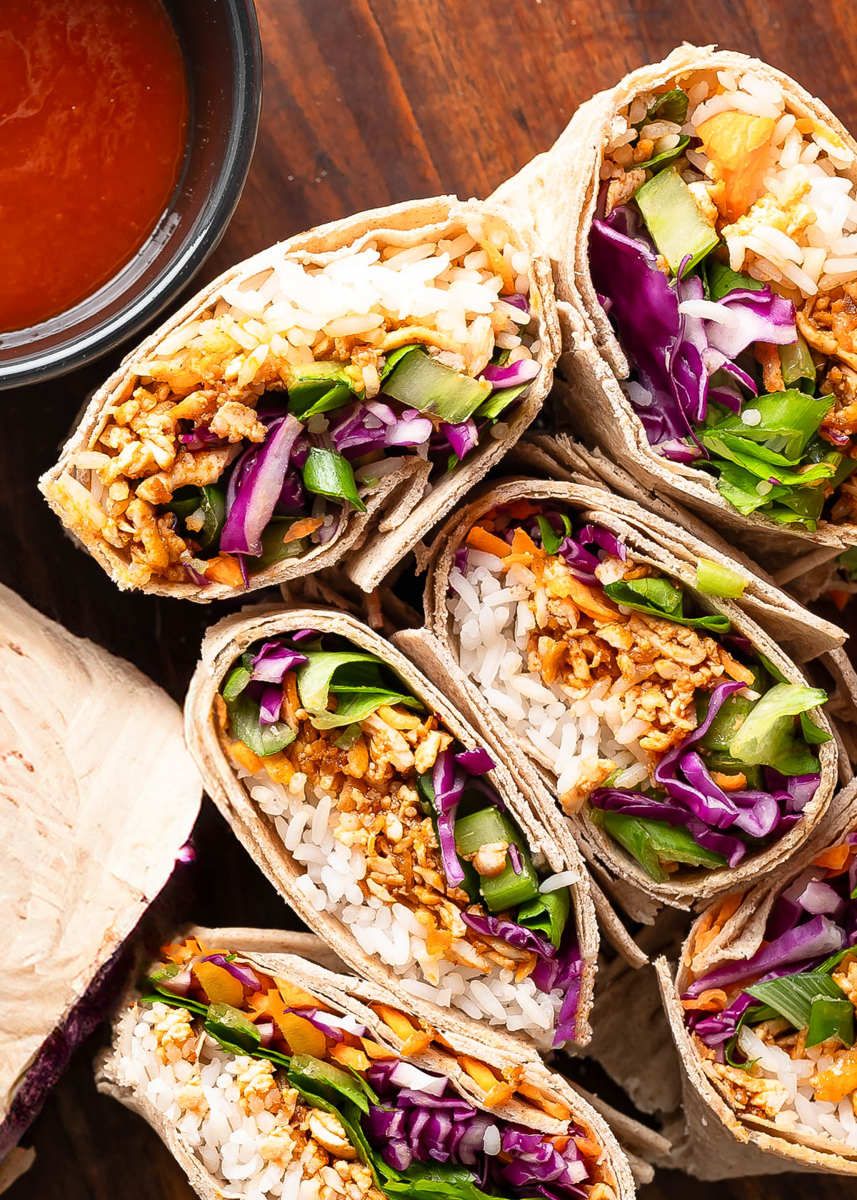 Shredded tofu wraps showing layers of tofu, rice and colorful vegetables.