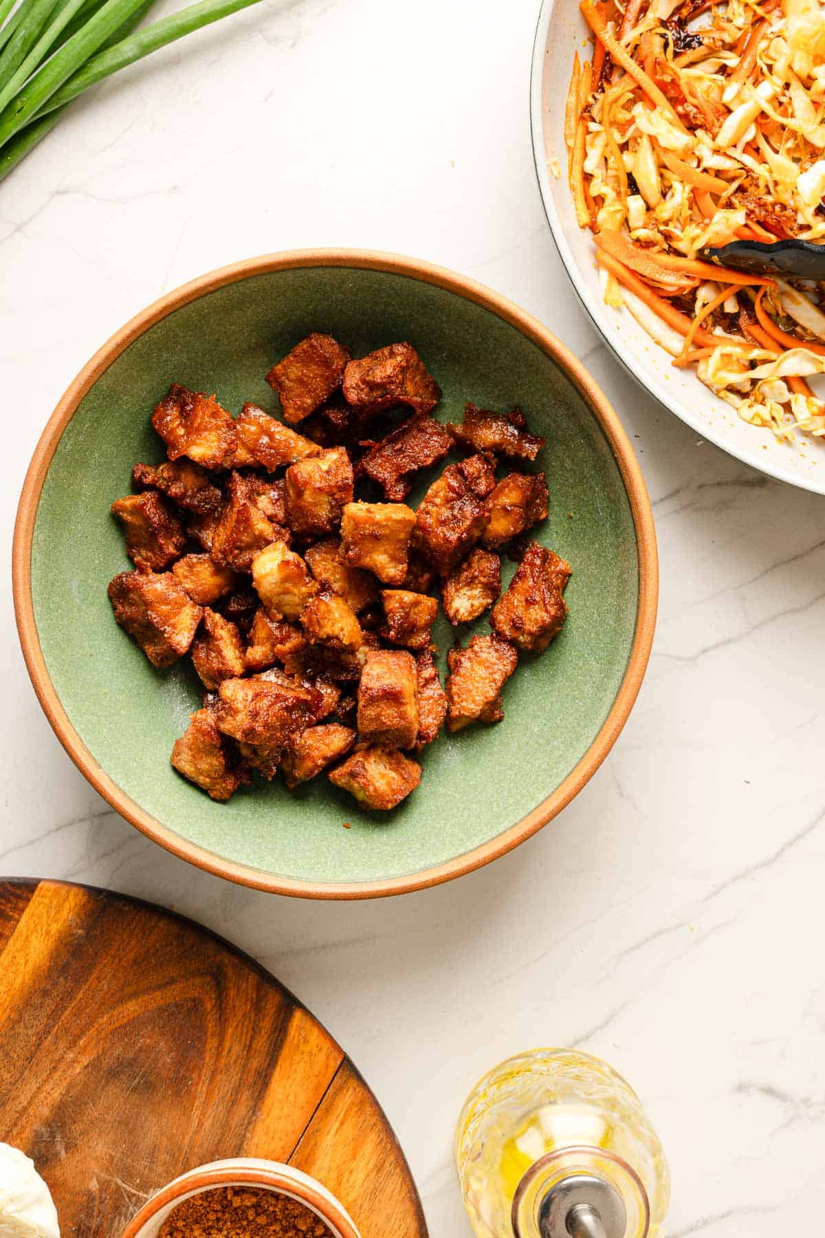 A bowl of cabbage stir fry and crispy tofu ready to be served