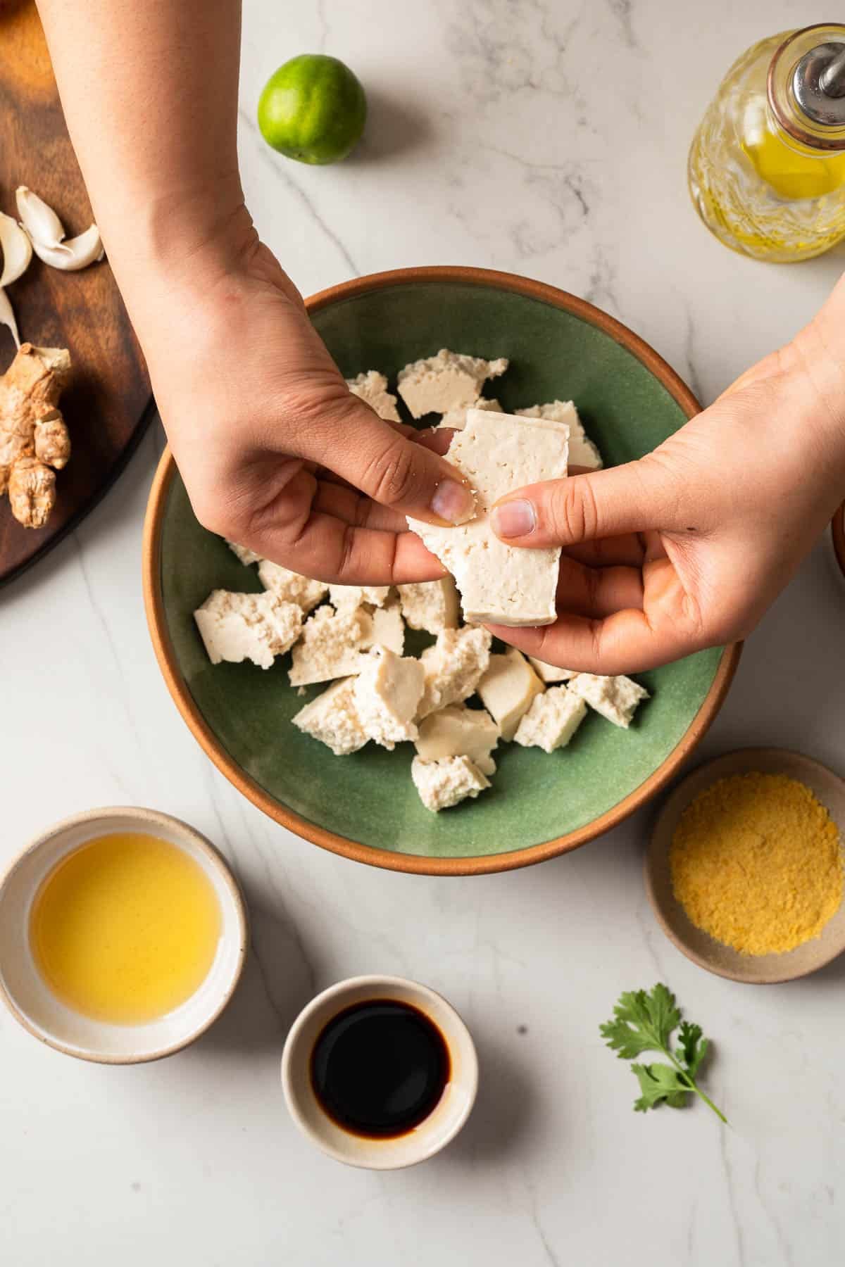 Breaking tofu into small chunks