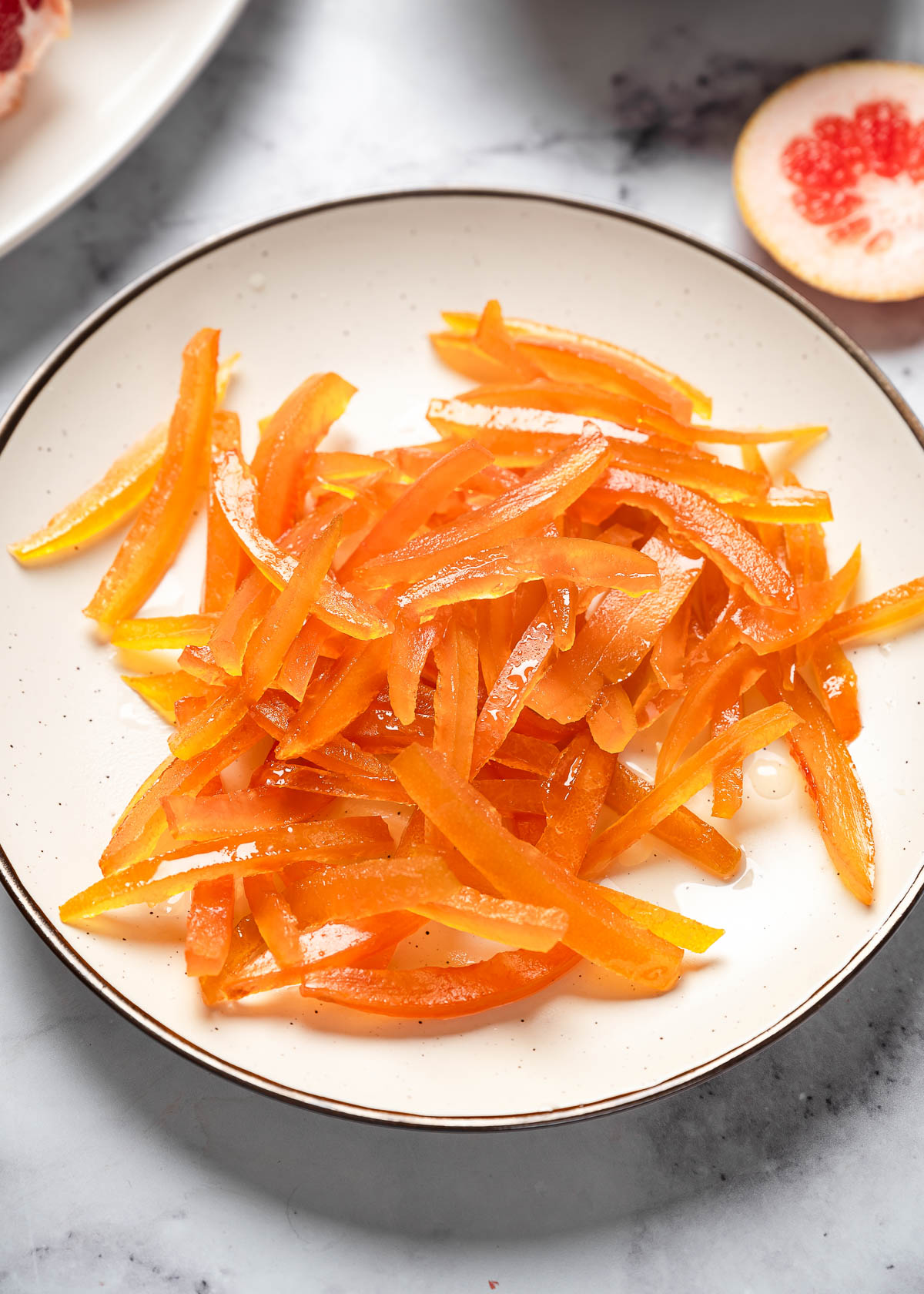 Translucent candied grapefruit peel on a plate