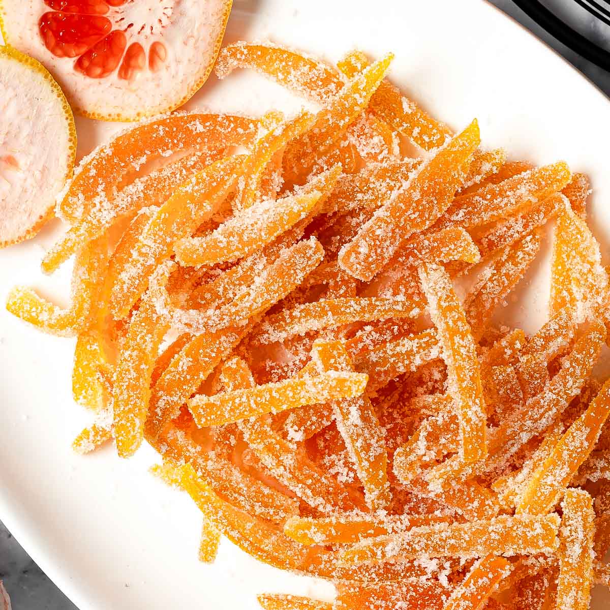 Sugary candied grapefruit peels piled on a serving dish