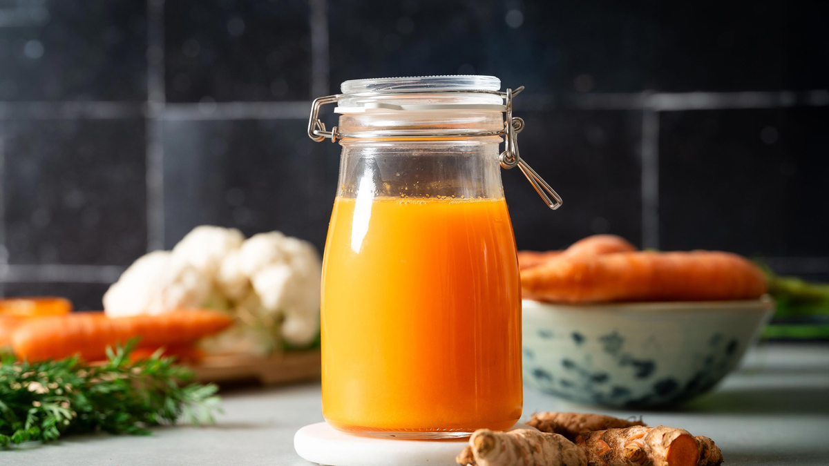 Fresh carrot turmeric juice in a glass
