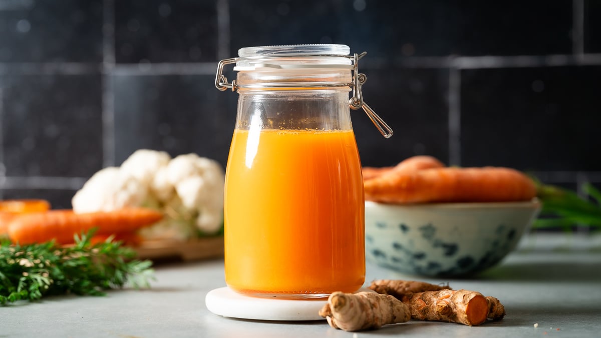 Fresh carrot turmeric juice in a glass