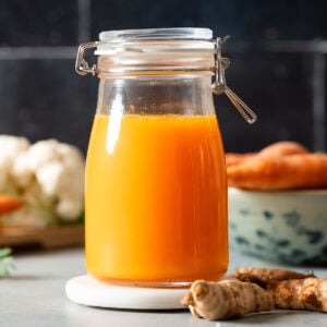 Fresh carrot turmeric juice in a glass