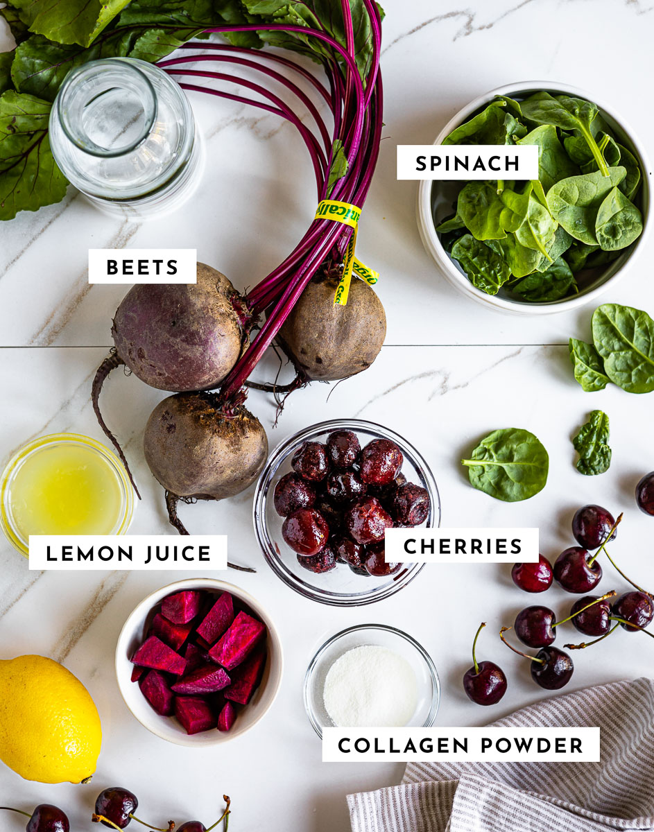 Labeled ingredients for making a cherry collagen smoothie, including spinach, cherries, lemon juice, and collagen powder.
