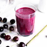 A close-up of a vibrant purple cherry collagen smoothie