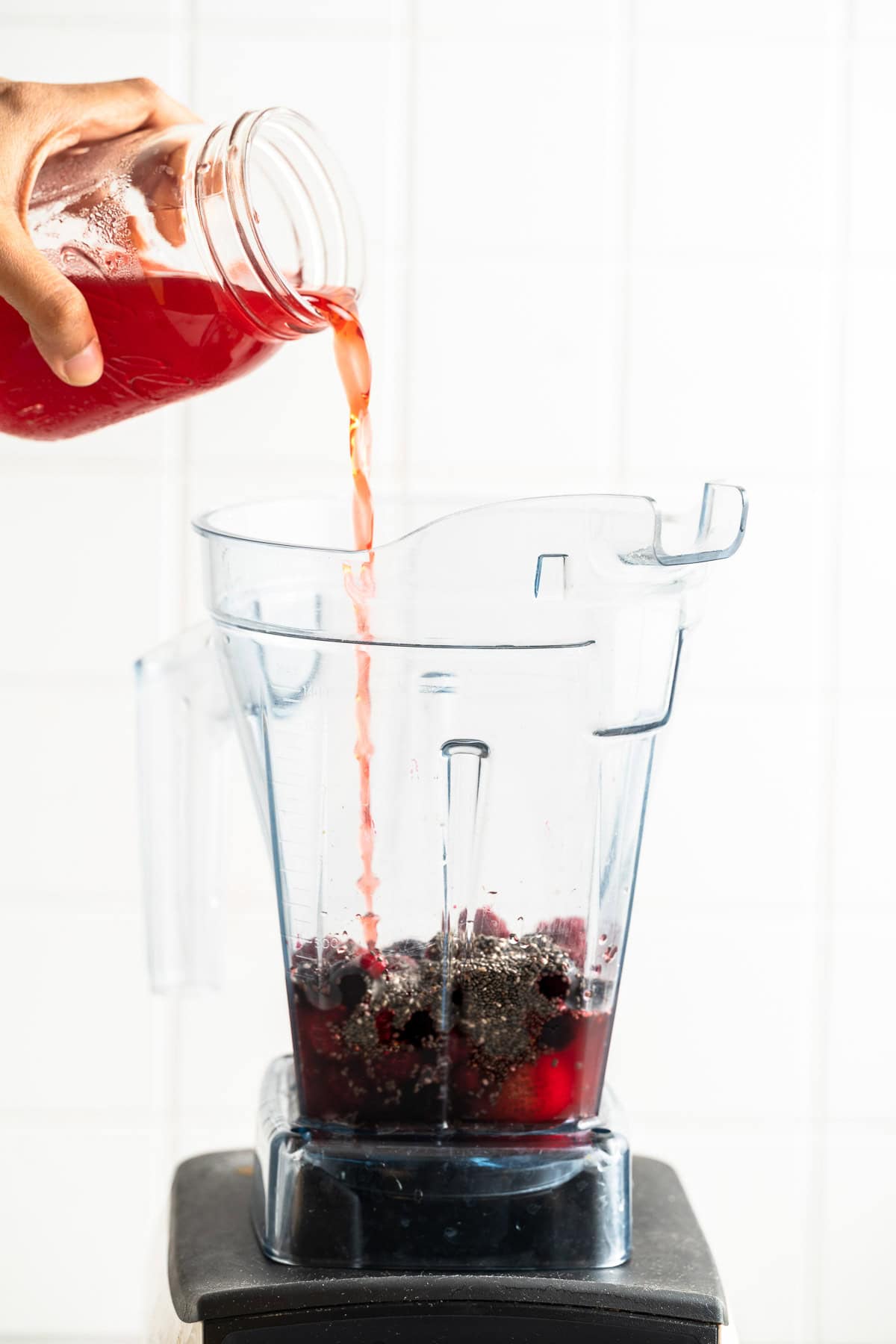 Pouring pomegranate juice into the blender