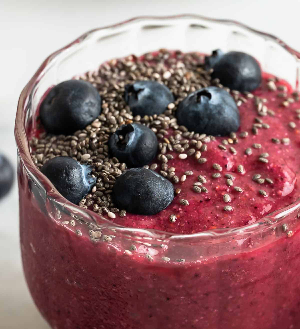 Vibrant chia fruit smoothie topped with chia seeds and blueberry