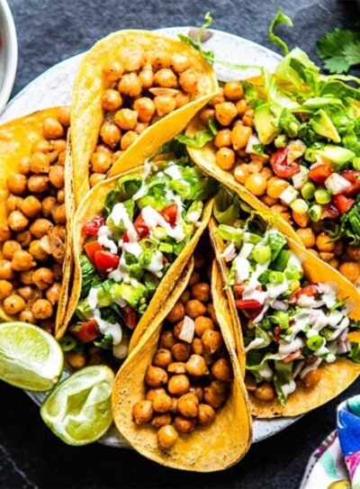 a plate full of chickpea tacos with fresh toppings